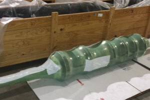 Large metal part shrink-wrapped with VCI shrink film for shipment