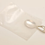 Silver jewelry secured in poly bag featuring ZERUST ICT520-CB1 Anti-Tarnish Film.