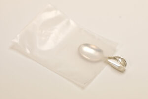 Silver jewelry secured in poly bag featuring ZERUST ICT520-CB1 Anti-Tarnish Film.