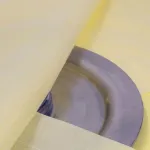 Close-up of VCI Plastic Scrim's woven strands on metal for added durability