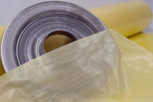 Metal part on roll of VCI Plastic Scrim illustrating effective corrosion prevention