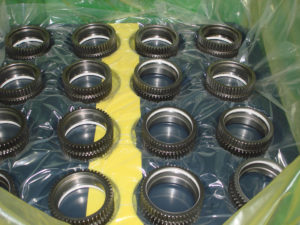 Metal components in returnable dunnage lined with cold seal VCI film.