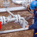 Field worker preparing pipeline for hydrostatic testing with hydrostatic testing corrosion inhibitor.