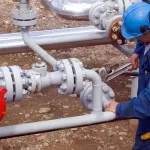 Field worker preparing pipeline for hydrostatic testing with hydrostatic testing corrosion inhibitor.