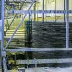 Technician using Acid Neutralizer in post-pickling rinse process.