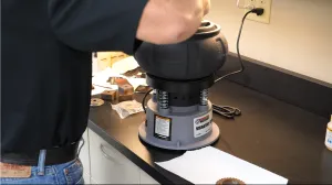 Vibrating tumbler washing metal parts in industrial parts washing process