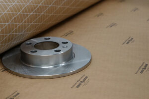 Brake rotor with Premium VCI Scrim Paper roll showcasing protection