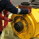 ZERUST AxxaCoat 90B HFS outdoor rust-preventative coating being applied to large oil and gas equipment for long-term protection.