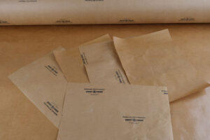 Sheets and roll of Poly VCI Kraft Paper showcasing comprehensive protection