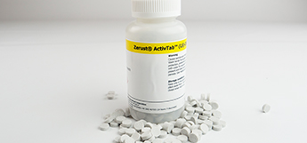Bottle and tablets of ZERUST ActivTab(LS) displayed on table