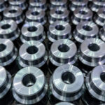 Batch of round steel parts cleaned with industrial parts washer for enhanced durability.