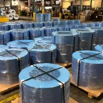 Metal coil secured with VCI Coil Covers and stretch film, demonstrating robust protection