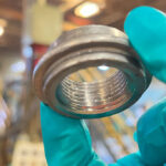 Close-up of a water heater coupling cleaned and protected by ZERUST Axxatec DA-23C, showcasing the invisible protective coating.