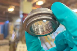 Close-up of a water heater coupling cleaned and protected by ZERUST Axxatec DA-23C, showcasing the invisible protective coating.