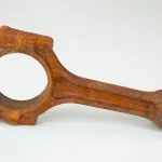 Rust-covered connecting rod before ZERUST AxxaClean ICT625-RR chelating rust remover treatment. Caption: See the extent of rust on this connecting rod before the ZERUST AxxaClean treatment