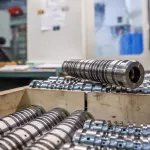 CNC-machined steel part coated with aluminum rust preventative and cleaner.