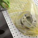 Brake rotor packaged in VCI poly tubing made from ZERUST ICT510-PCR30 VCI Film, demonstrating advanced corrosion protection.