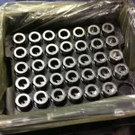 ZERUST Axxanol 750-NV rust preventive oil applied on metal parts on a tray, packaged in ZERUST VCI for optimal corrosion protection