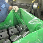 Manufacturing employee transporting stamped parts in ZERUST VCI Film