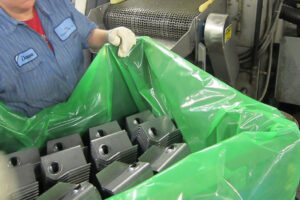 Manufacturing employee transporting stamped parts in ZERUST VCI Film