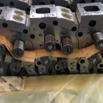 Engine components on a pallet covered by protective sheeting before packaging.