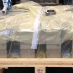 Engine components packaged in protective sheeting for corrosion prevention during storage and transport.