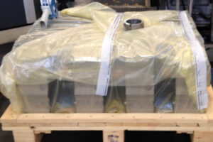 Engine components packaged in protective sheeting for corrosion prevention during storage and transport.