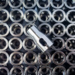 Machined metal parts coated with yellow metal rust preventative and cleaner.