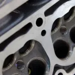 Engine close-up demonstrating ZERUST Axxanol 758 VCI Oil protection in crevices and chambers.