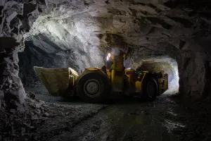 Excavator operating at a mining site, addressing mining corrosion challenges.