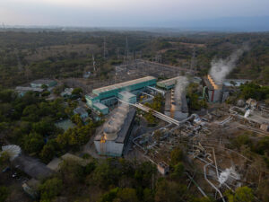 Geothermal power plant with steam turbines and cooling towers.
