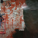 Maintenance team removing corrosion without VCI for shipbuilding