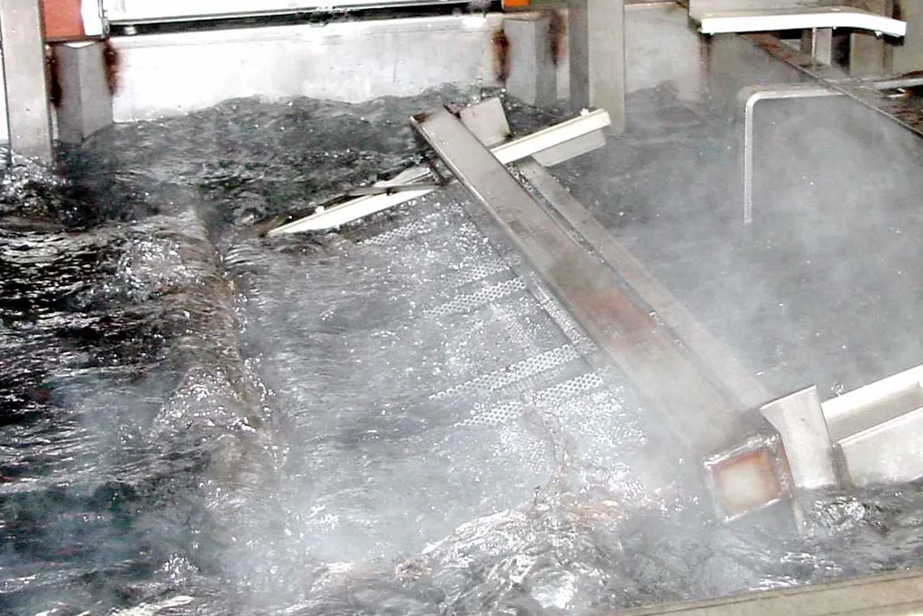 Metal part immersed in ZERUST AxxaWash hard water parts cleaner during the wash cycle