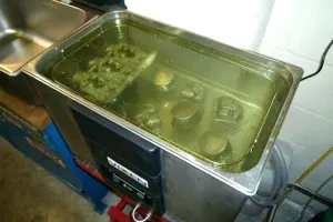 Metal parts cleaned in ultrasonic tank using flash rust inhibitor cleaner.