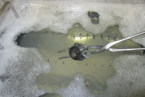 Close-up of part during ultrasonic parts washer cleaner process with ZERUST AxxaWash