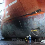 Wide-angle view of wet vapor blasting on a ship hull